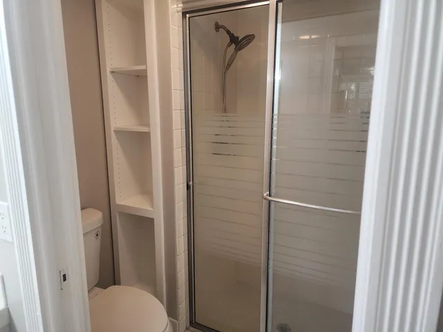 a bathroom that has a glass shower door