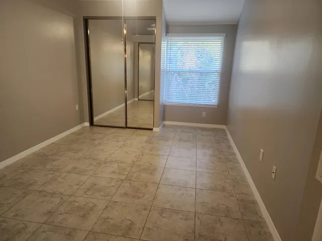 an empty room with entrance and bathroom