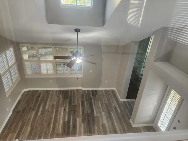 a view of empty room with wooden floor