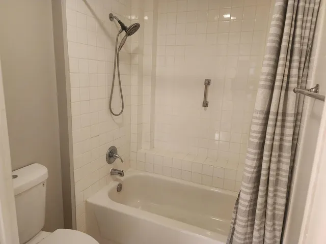 a bathroom with a bath tub with a shower