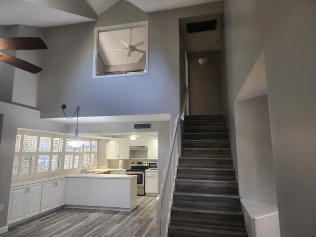 a view of a kitchen with wooden floor and windows