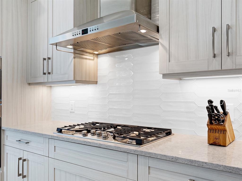 8043 Waterbend Trail Sarasota, FL 34240 - Photo 20 of 83 a kitchen with white cabinets and appliances