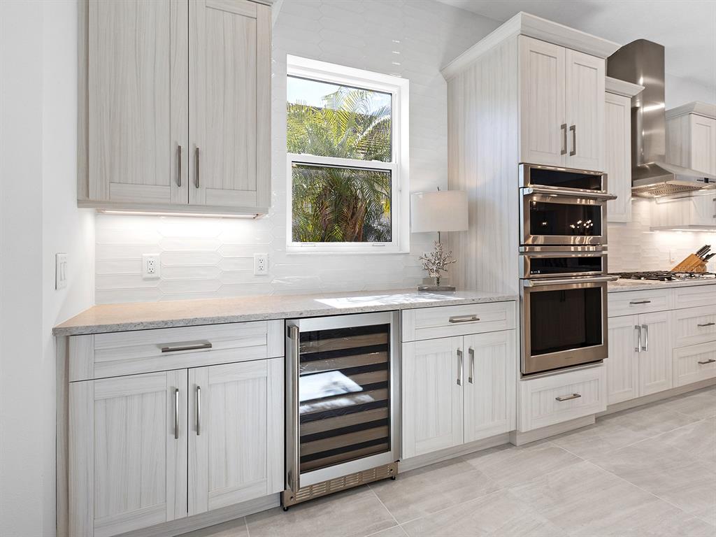 8043 Waterbend Trail Sarasota, FL 34240 - Photo 22 of 83 a kitchen with white cabinets and white appliances