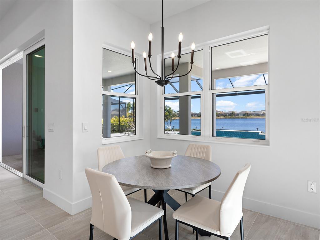 8043 Waterbend Trail Sarasota, FL 34240 - Photo 24 of 83 a view of a dining room with furniture and wooden floor