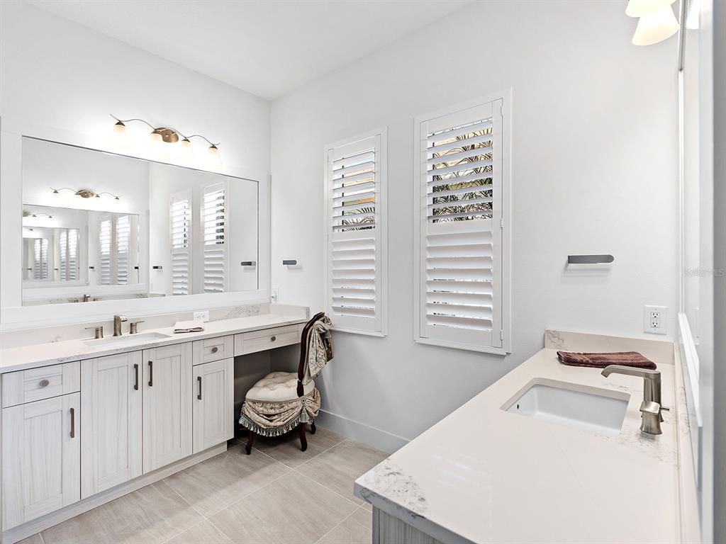8043 Waterbend Trail Sarasota, FL 34240 - Photo 30 of 83 a bathroom with a sink a toilet and a mirror