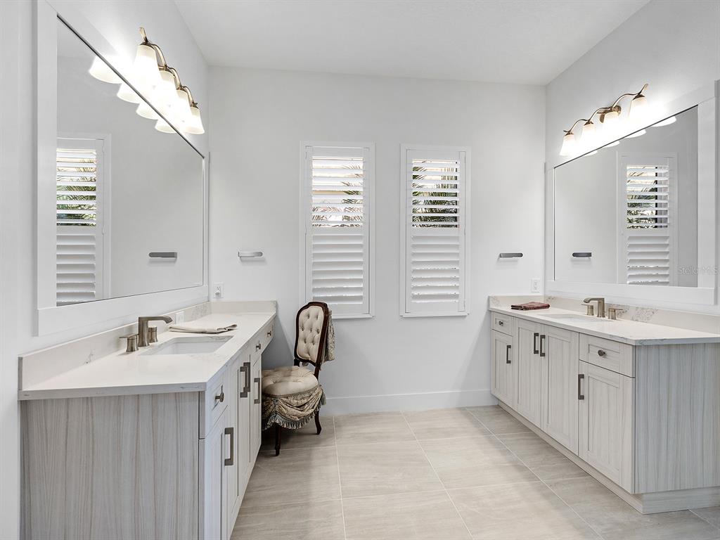 8043 Waterbend Trail Sarasota, FL 34240 - Photo 31 of 83 a bathroom with a double vanity sink mirror and a bathtub