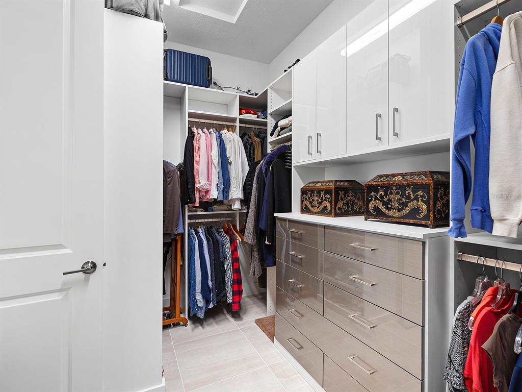 8043 Waterbend Trail Sarasota, FL 34240 - Photo 34 of 83 a view of walk in closet with clothes and shoes