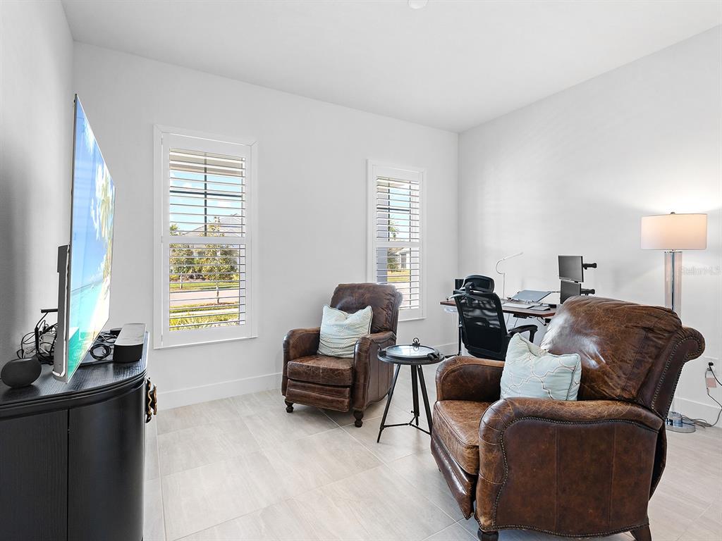 8043 Waterbend Trail Sarasota, FL 34240 - Photo 37 of 83 a living room with furniture and a flat screen tv