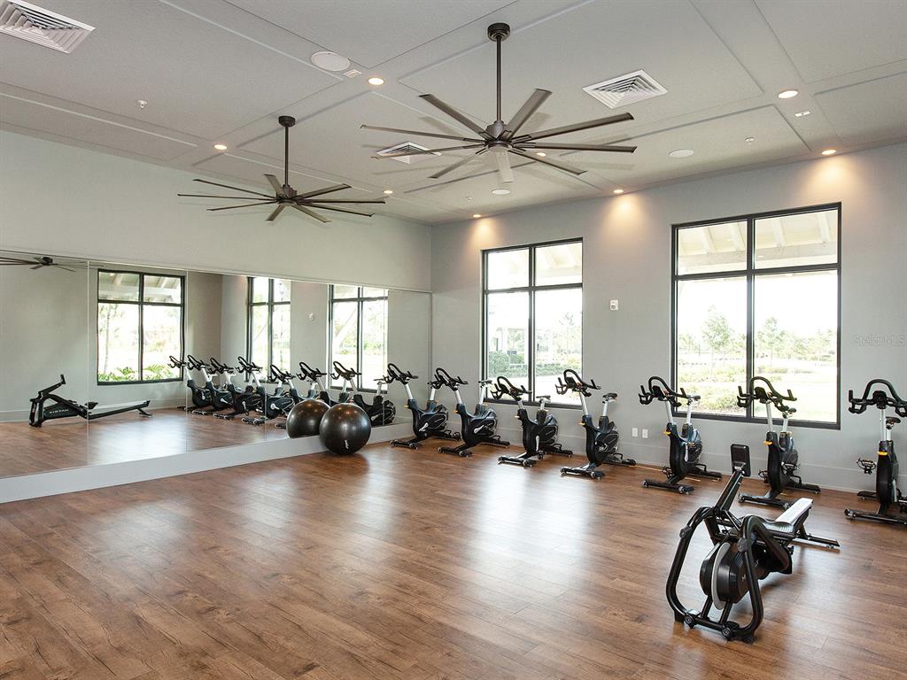 8043 Waterbend Trail Sarasota, FL 34240 - Photo 76 of 83 a view of a livingroom with furniture hardwood floor and a large window