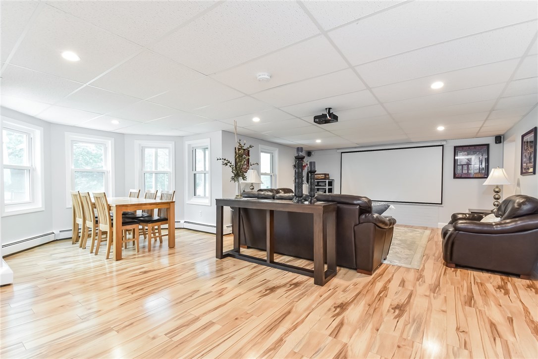 410 Trimtown Road Scituate, RI 02857 - Photo 26 of 39 Entertainer's dream! Lower level family room with huge movie screen, tons of play or party space and ample room for dining Walks out to new pretty patio. Direct access to storage and garage.