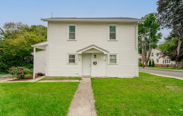 a front view of house with yard and green space