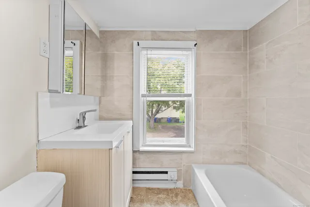 a bathroom with a sink a toilet and a bathtub