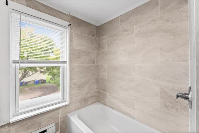 a bathroom with a bathtub and a shower