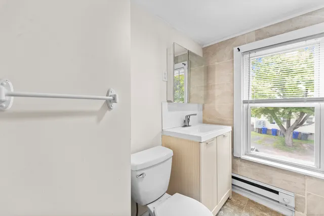 a white toilet sitting next to a bathroom sink