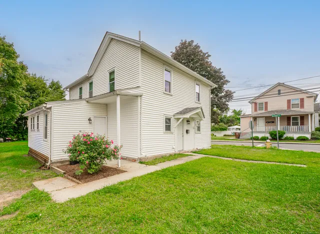 a front view of house with yard and green space