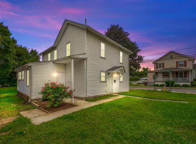 a front view of a house with a yard