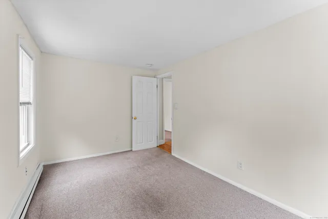 a view of an empty room and a window