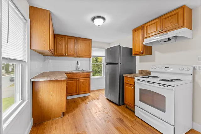 a kitchen with a refrigerator sink and stove