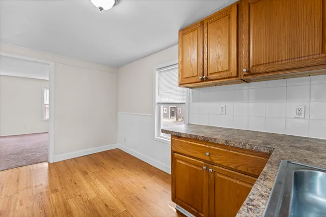 a kitchen with granite countertop wooden cabinets and a sink