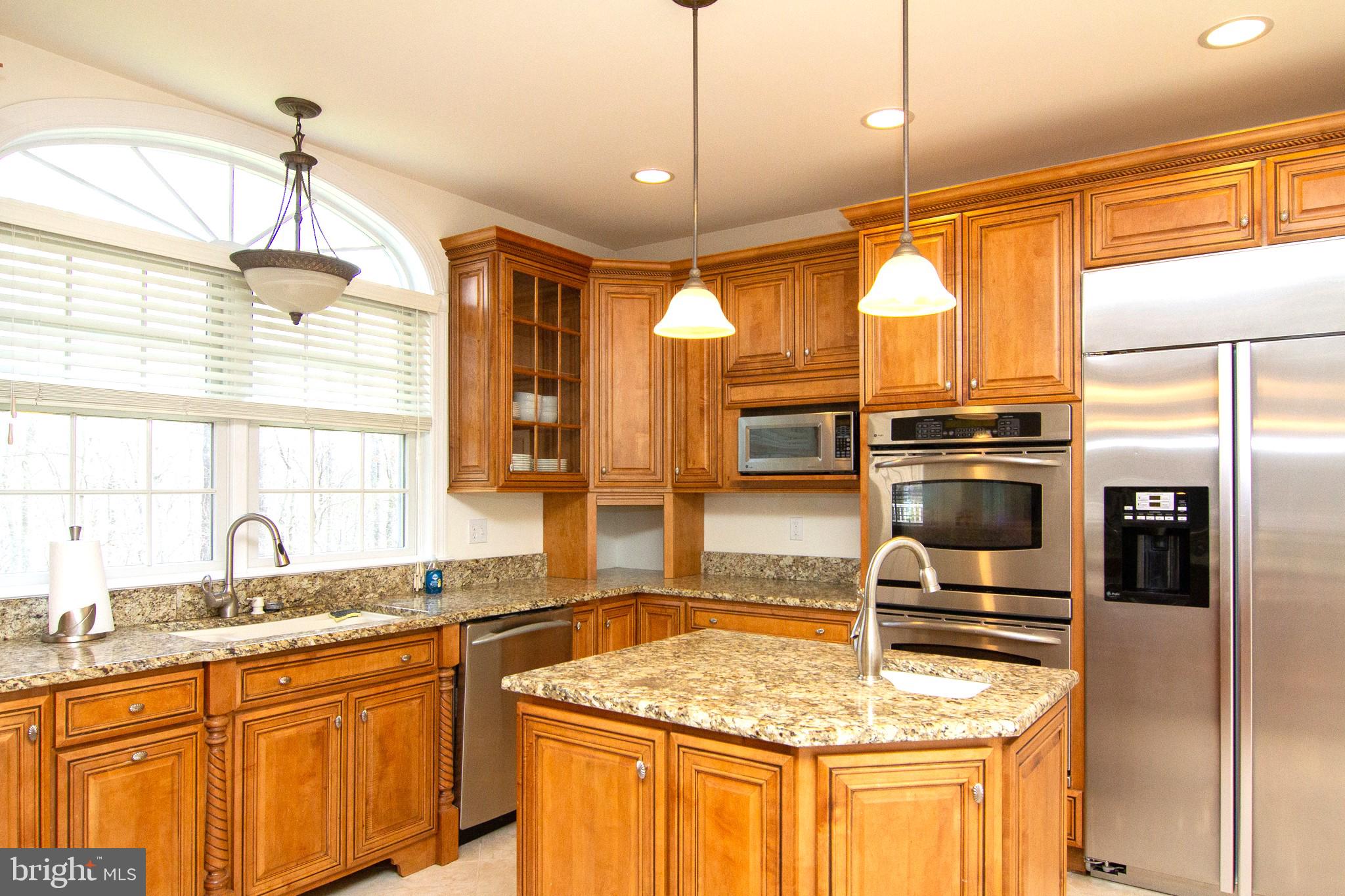 2089 Brown Road Finksburg, MD 21048 - Photo 9 of 31 a kitchen with stainless steel appliances granite countertop a sink a stove and a refrigerator