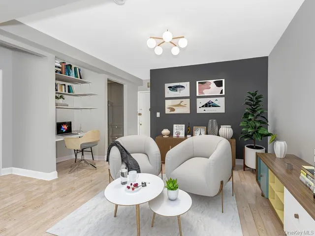 a living room with furniture and a potted plant