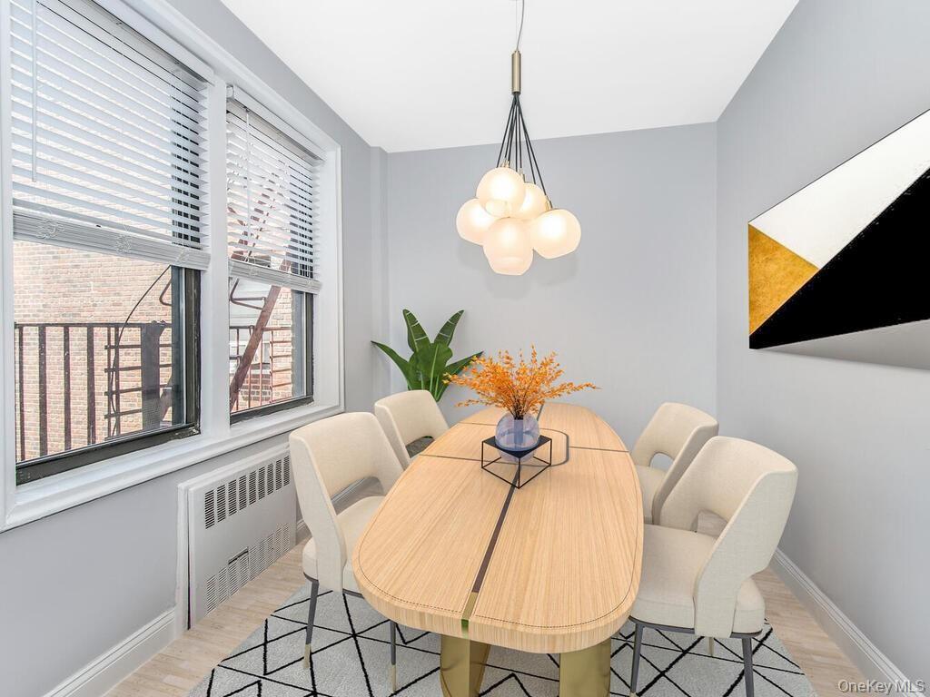 645 West 239th Street, Unit 4D Bronx, NY 10463 - Photo 6 of 13 Dining area with radiator heating unit and light wood-style flooring