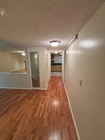 a view of hallway with wooden floor