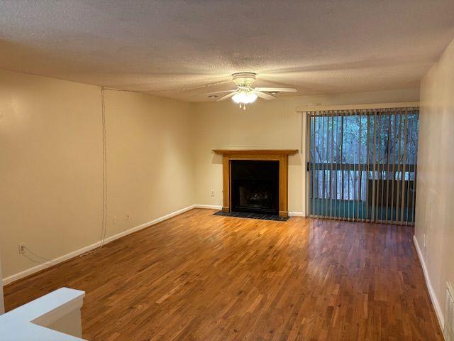 38 Rumson Court Smyrna, GA 30080 - Photo 2 of 38 a view of empty room with wooden floor and fireplace