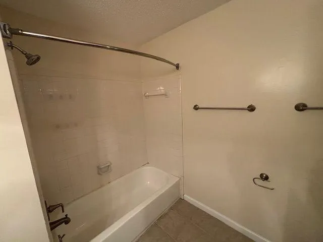 a bathroom with a shower and a bath tub