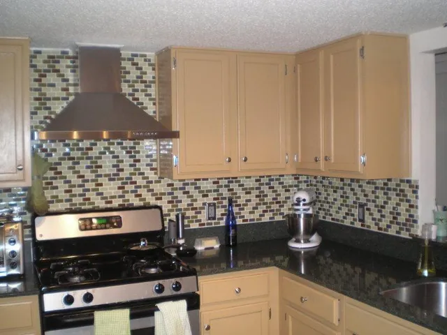 a kitchen with granite countertop a sink and a stove