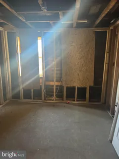 a view of an empty room with wooden floor and a glass door