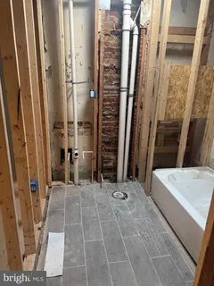 a view of bathroom with a tub and shower
