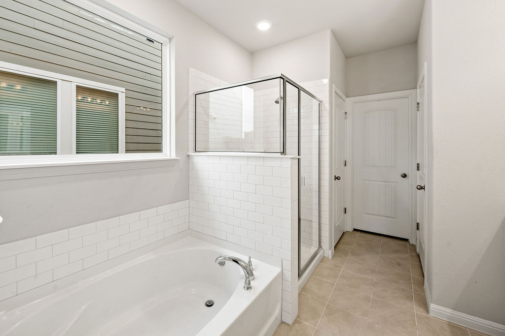 2417 Roosevelt Road Leander, TX 78641 - Photo 3 of 40 Full bathroom with a garden tub, light tile patterned floors, and a shower stall