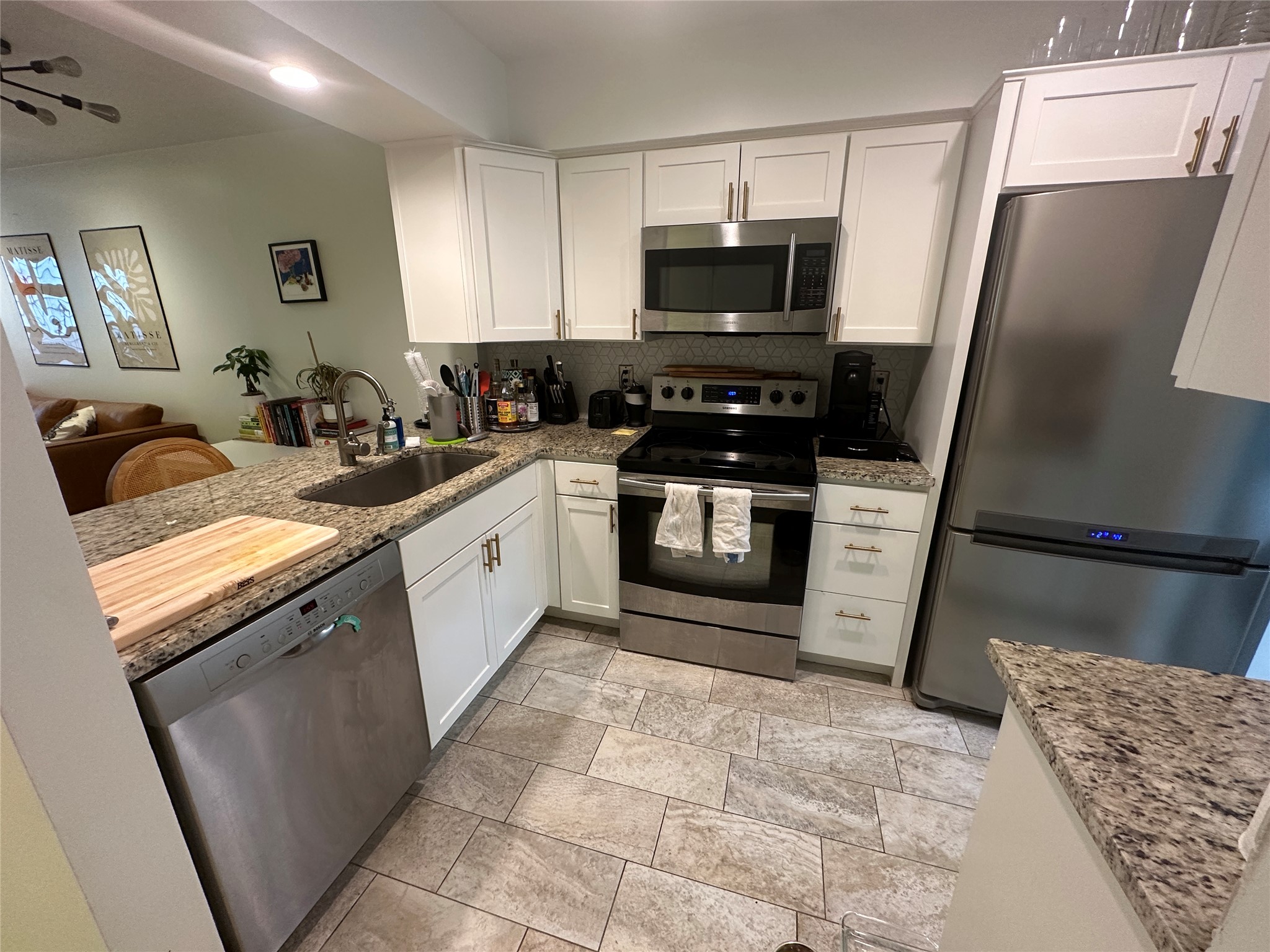 2215 Post Road, Unit 2002 Austin, TX 78704 - Photo 3 of 12 a kitchen with stainless steel appliances granite countertop a sink stove and refrigerator