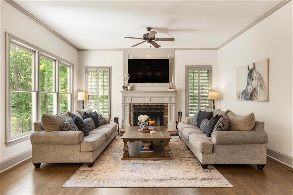 3910 Two Rivers Drive Cumming, GA 30041 - Photo 23 of 110 a living room with furniture a flat screen tv and a fireplace