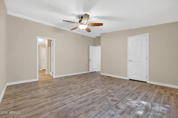 a view of an empty room with wooden floor