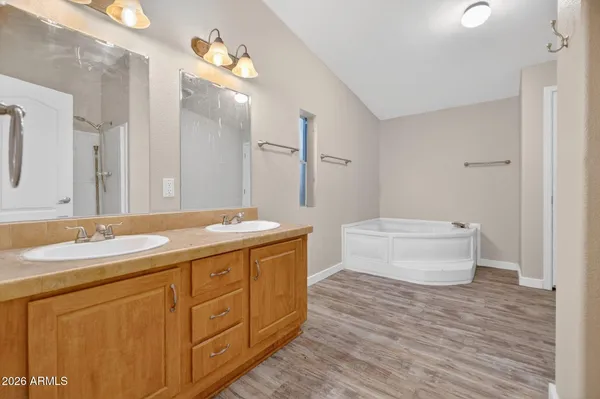 a spacious bathroom with a granite countertop sink a toilet and a mirror