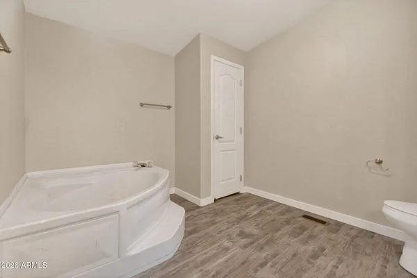 a bathroom with a bathtub and toilet
