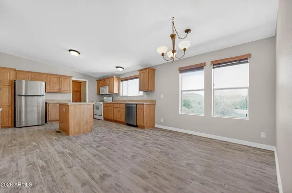 a view of a kitchen with a sink dishwasher and a refrigerator