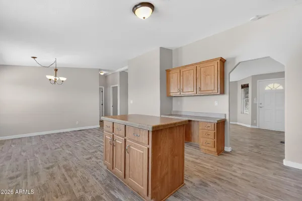 a view of kitchen with wooden floor and electronic appliances