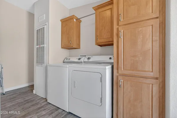 a utility room with cabinets washer and dryer