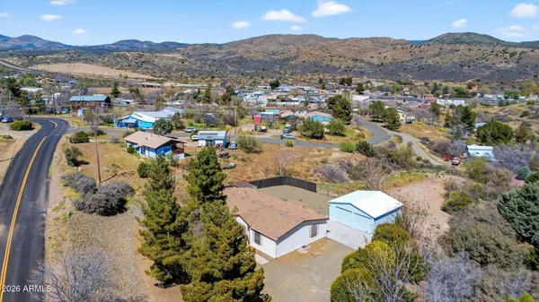 an aerial view of a house with a mountain