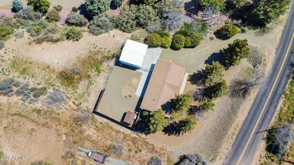 an aerial view of a house with a yard and lake view