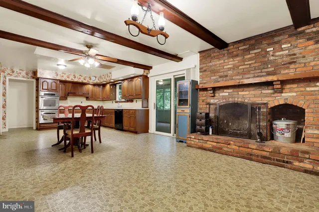 a view of a dining room with furniture and a chandelier