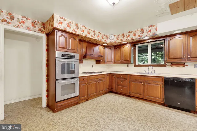 a kitchen with stainless steel appliances granite countertop a stove and cabinets