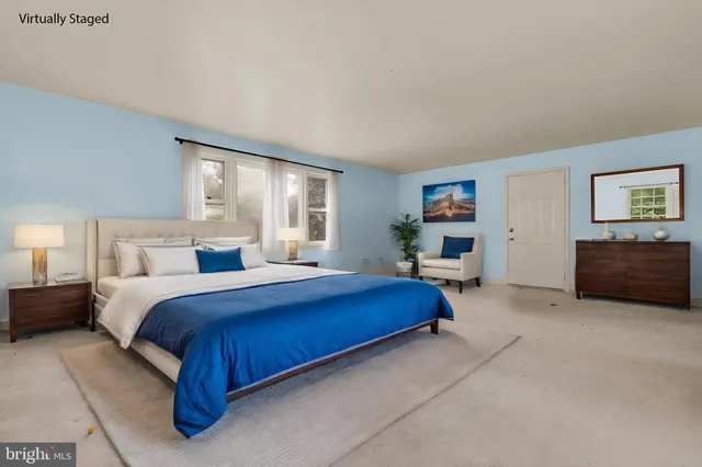 a spacious bedroom with a bed and furniture