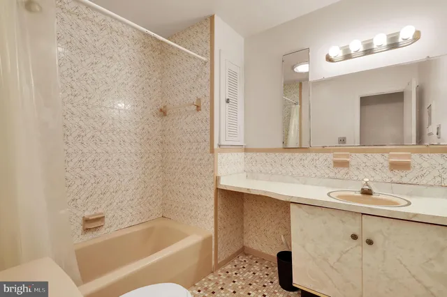a bathroom with a sink mirror and a bathtub