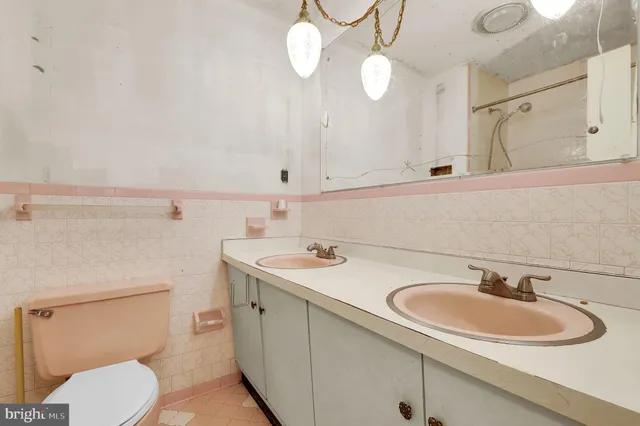 a bathroom with a sink a toilet and mirror