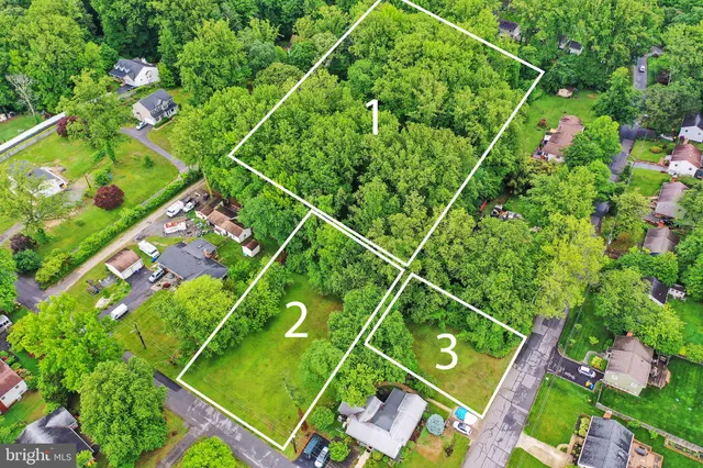 a backyard of a house with lots of green space and trees