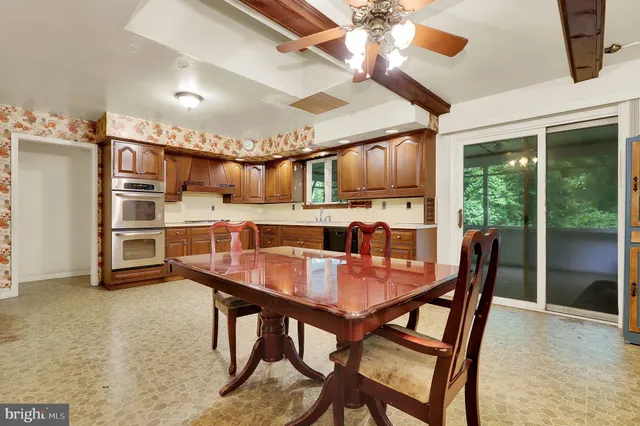 a dining room with furniture and window
